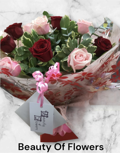 Red and Pink Roses Watered Hand Tied Delivered in Derby and Derbyshire - This beautiful bouquet is something unique. Top quality Pink and Red Roses surrounded by lush green foliage's and wrapped already in water.