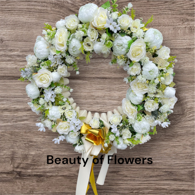 Artificial White and Gold Wreath - This stunning and beautiful artificial white and gold wreath comes in an impressive size of  approx. 27" diameter. Lovingly prepared personally by our talented florist in our Derby city store. This design can be made in other colour choices. We can also personalise this design with a ribbon sash with a name or short message. Please contact us to discuss your requirements