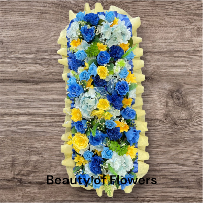 Artificial Blue and Yellow Flower Bar - This stunning and beautiful artificial Blue and Yellow Flower Bar comes in a size of approx. 27". Lovingly prepared personally by our talented florist in our Derby city store, each design is unique and individual. Flower variety may vary from the picture, but the colour will remain the same. This design can be made in other colour choices. We can also personalize this design with a ribbon sash with a name or short message. Please contact us to discuss your requirements. Artificial funeral flowers are becoming ever more popular due to the fact they last much longer and are a fraction of the price of fresh.