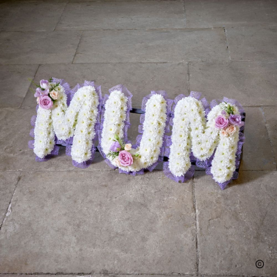 Based MUM letters OFP25(C) - Each letter is created using a ribbon colour of your choice, white chrysanthemum base and a spray on each letter in a colour and flower of your choosing.

 Any wording or name can be spelt Prices start at £40.00 per letter.

Made and delivered with love and care.  We do our best to replicate the design shown but sometimes nature has other ideas. Our flowers and foliage are fresh and seasonal which means that substitutions within our designs will sometimes have to be made where necessary. As our product are natural there might be slight colour variations. Don’t hesitate to contact us if you want clarification

All of our designs can be carefully customise to make ordering funeral flowers that little bit more personal. We deliver to all the local funeral directors, so rest assured we take care of every aspect of the funeral flowers and ensure they are delivered in good time and in pristine condition.

If you prefer to discuss face to face, please come into the shop to view our wide selection of pictures, please be assured we are very experienced florists delivering many varied funeral tributes week by week