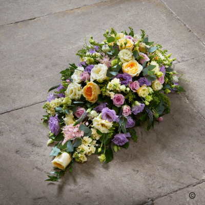Single Ended Oasis Spray - OFP25(D) - In times of loss, a traditional teardrop-shaped spray created with a mixed selection of colours and flowers. A fitting tribute from acquaintances, colleagues, friend, or family.

 A single ended tear drop spray of flowers is rounded on one end and pointed on the other. Ideal if more that 1 tribute is wanted on top of the coffin. Available in mixed variety of flowers and foliage in Pink, White, Yellow, Red, Orange or Purple.