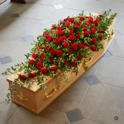 Red Rose Coffin Spray OFP16 - The ultimate last gift of love is the classic full length coffin spray of deep red roses. Dark green foliage enhances the red roses in this evocative message of love.