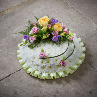 Based Posy OFP9(B) - A traditional posy with a ribbon edge, white chrysanthemum base and a spray of flowers on top. This design can be customised in the favourite colouring of the deceased.