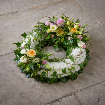 Modern Based Wreath OFP9A - Pastel-coloured based wreath with lush green foliage. Comes designed in 3 sizes.
