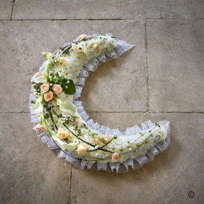 Crescent Moon - Crescent Moon tribute with soft ribbon edging, white base and peach and white spray. Can be made in other colours of edge and spray. Size approx 50cm
