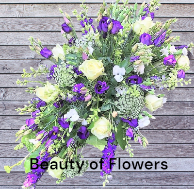 Purple and White Coffin Spray - Purple and White Flower Coffin Spray of mixed flowers and foliage. Available in Pink and Blue, Yellow and Orange or White and Cream. An ideal tribute to sit on top of the coffin from the next of kin or family. 
Made and delivered with love and care.  We do our best to replicate the design shown but sometimes nature has other ideas. Our flowers and foliage are fresh and seasonal which means that substitutions within our designs will sometimes have to be made where necessary. As our product are natural there might be slight colour variations. Don’t hesitate to contact us if you want clarification

All of our designs can be carefully customise to make ordering funeral flowers that little bit more personal. We deliver to all the local funeral directors, so rest assured we take care of every aspect of the funeral flowers and ensure they are delivered in good time and in pristine condition.

If you prefer to discuss face to face, please come into the shop to view our wide selection of pictures, please be assured we are very experienced florists delivering many varied funeral tributes week by week.
